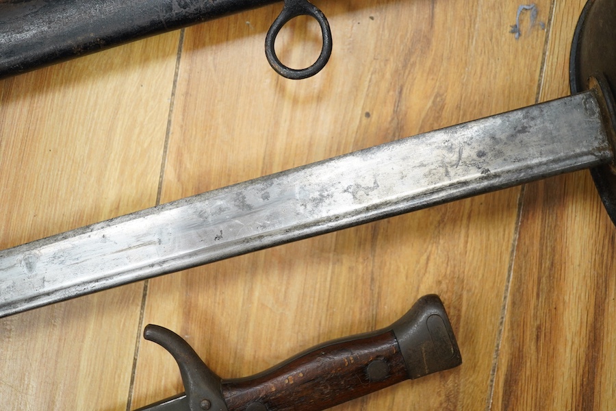 A First World War Turkish army officer’s sword, with pipe back blade, regulation iron guard pierced with crescent and moon, chequered horn grips, in its iron scabbard, together with an unidentified bayonet in its scabbar